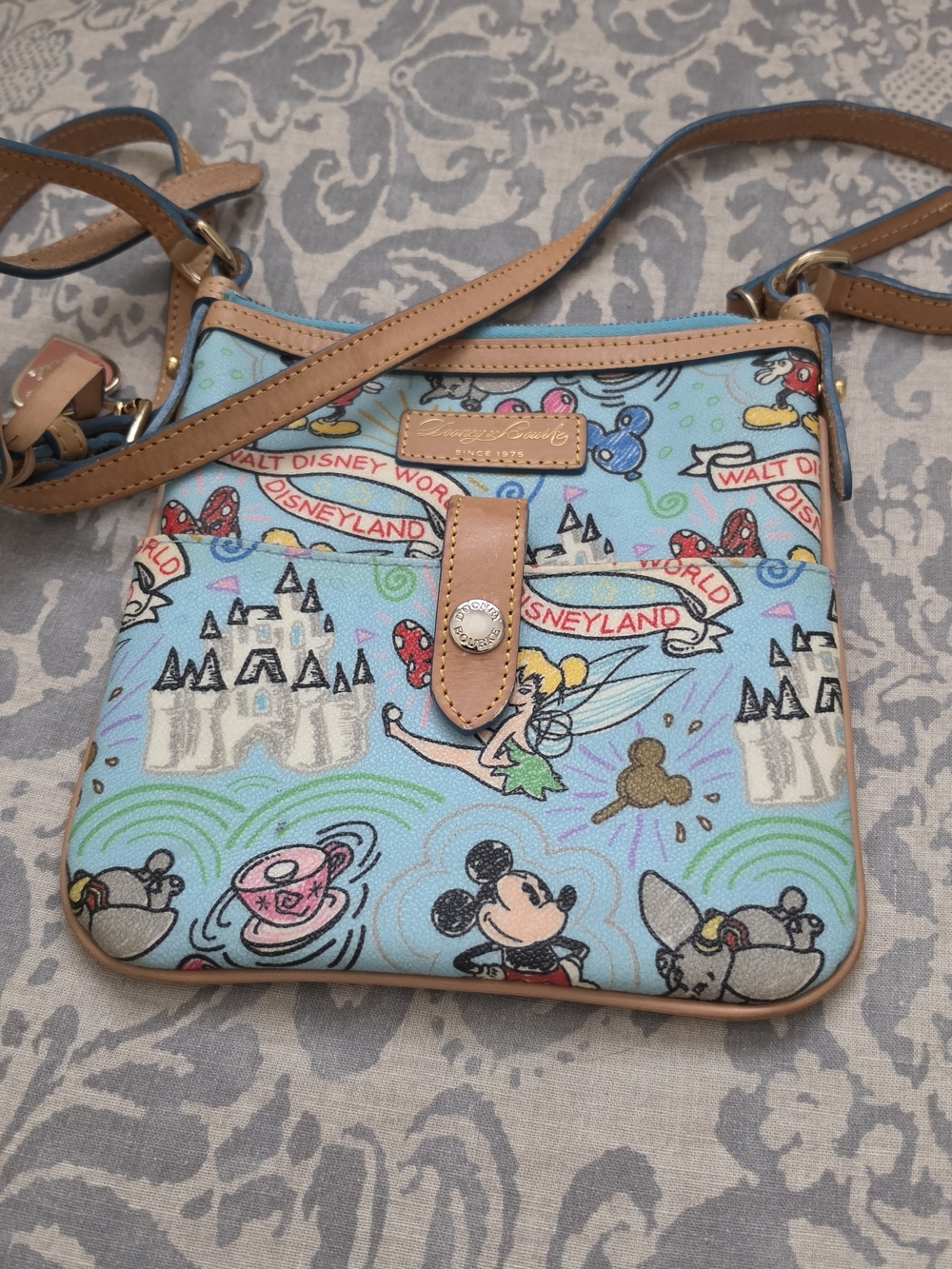 Dooney & Bourke Light Blue Disneyland Print Crossbody with Tan Trim. New